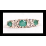 A hallmarked 9ct gold emerald and diamond gypsy set ring. Hallmarked London. Weight 2.8g. Size O.