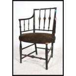 A 19th century Regency mahogany armchair having an original ebonised painted finish with remains