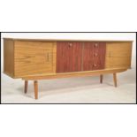 A vintage mid century sideboard raised on tapering