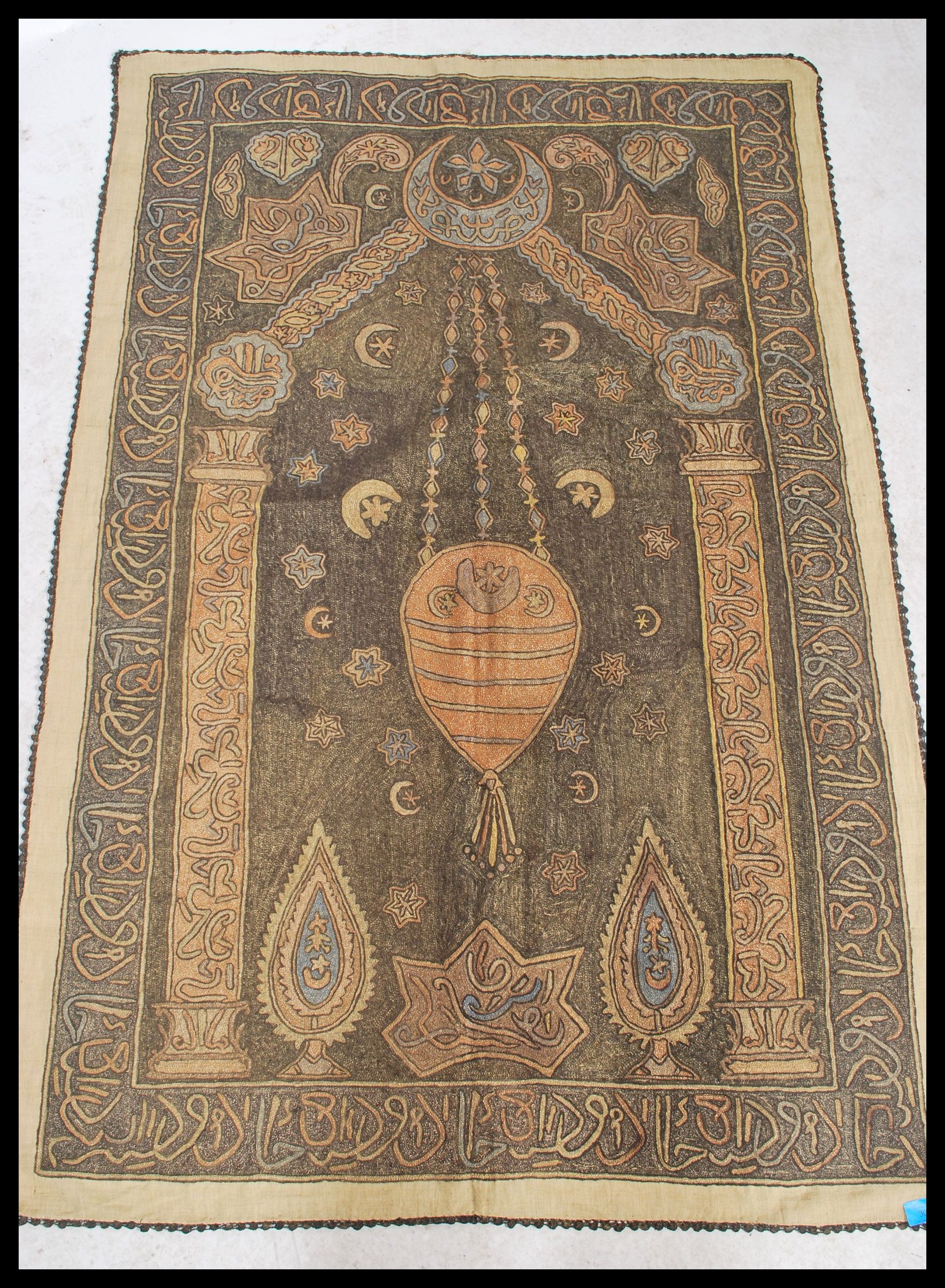 An unusual early 20th century Islamic hanging tapestry with geometric spandrels and borders having a - Image 2 of 4