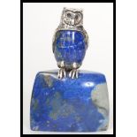A vintage 20th century silver plated figurine of an owl mounted on a lapis lazuli base. Measures 8