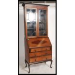 A vintage 20th century mahogany inlaid bureau bookcase, astragal glazed upper section over a fall