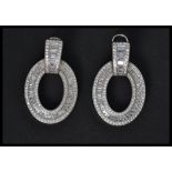 A pair of sterling silver and CZ earrings of roundel form. Weighs 11 grams.