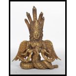 A 19th century Chinese gilt bronze Buddha having wings and snakes protruding from the back. Measures