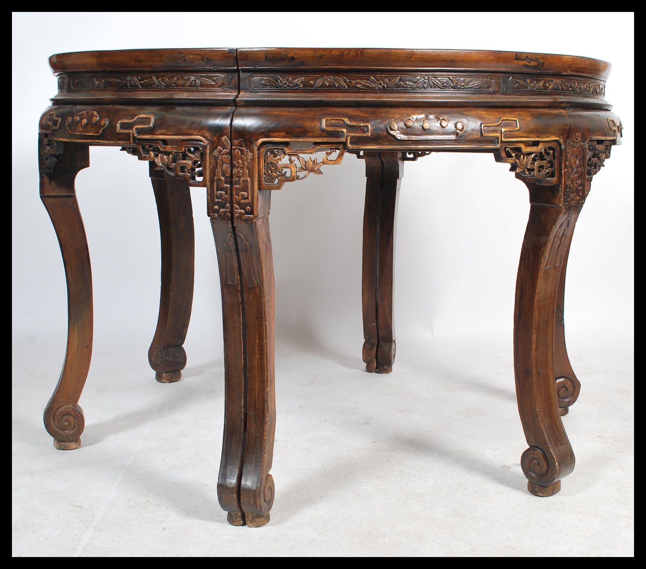 A large antique 20th century Chinese circular dining table from the Zhejiang province. The table
