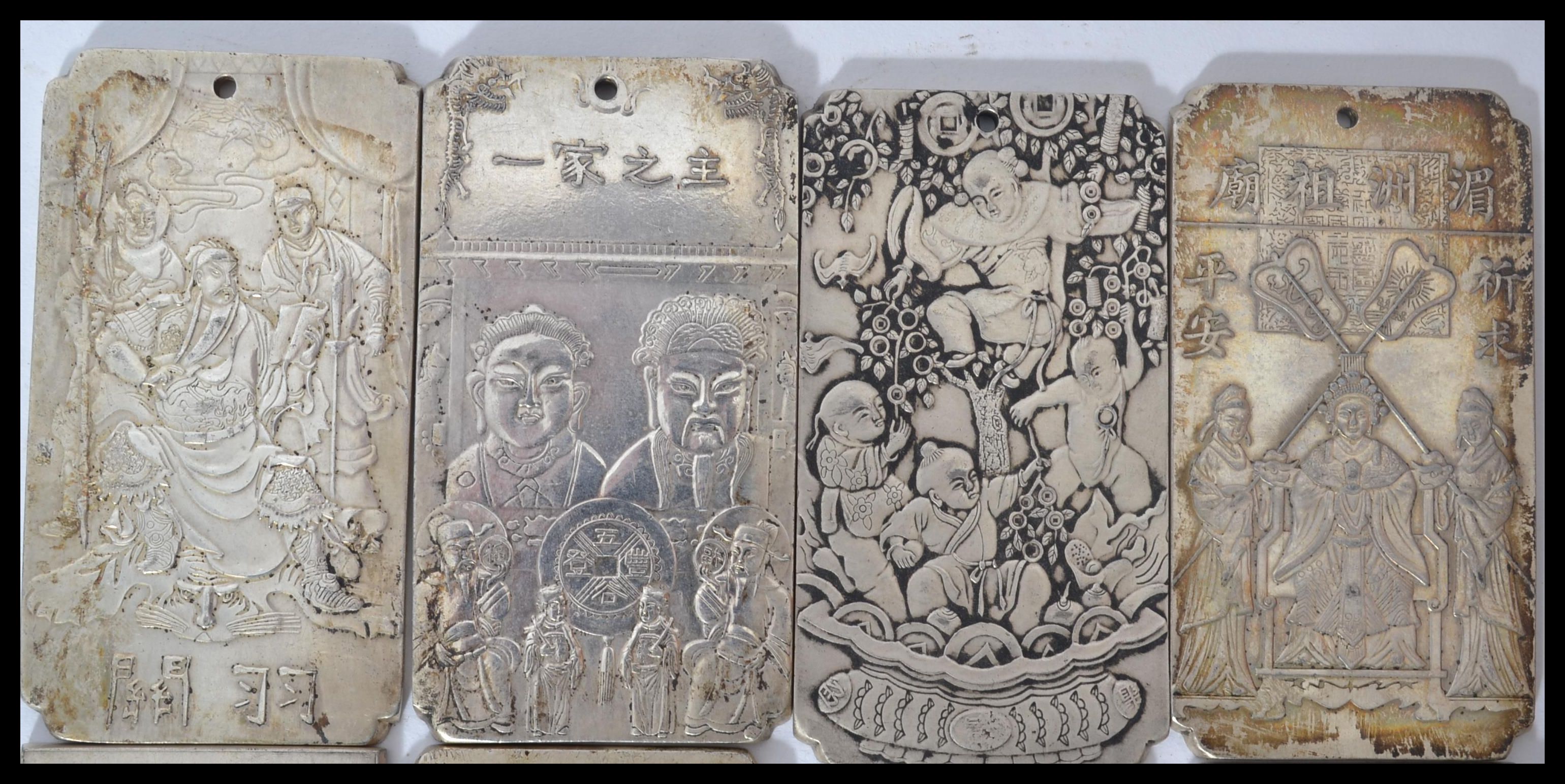 A collection of eight Chinese white metal amulet / scroll weights, cast in relief with various - Image 3 of 5