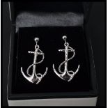 A pair of sterling silver earrings in the form of anchors with rope. Complete in presentation box.