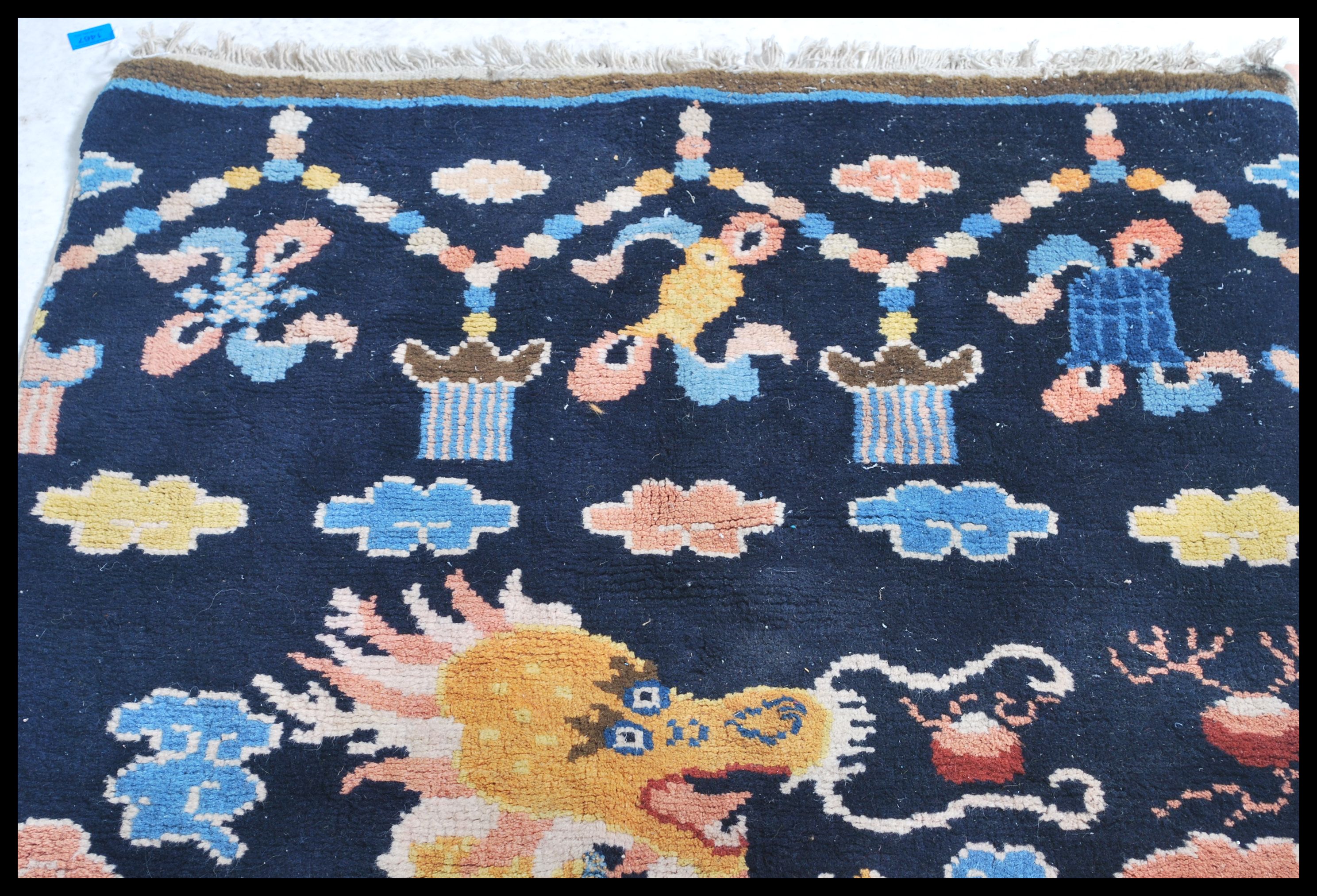 An early 20th century Tibetan dragon rug. The blue ground with large continuous dragon with - Image 4 of 6