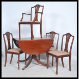 A Regency revival mahogany drop leaf dining table raised on a reeded leg pedestal base with brass