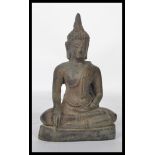 A 19th century Chinese bronze Buddha figurine modelled in the Lotus position raised on a pedestal