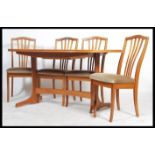 A retro 20th century Danish inspired teak wood dining table and chairs set, extendable dining