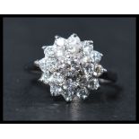 A contemporary  ladies 20th century 18ct white gold diamond cluster ring, together with valuation