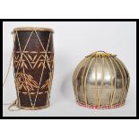 A 20th century African style tribal Djembe drum together with another drum constructed from