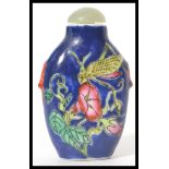 A Chinese porcelain snuff - perfume bottle with glass stopper with dabber stem. Blue ground with