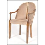 A 20th century Art Deco mahogany elbow chair havin