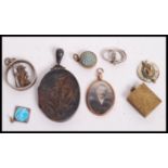 A group of silver gold and yellow metal jewellery pendants to include a hallmarked silver pendant,