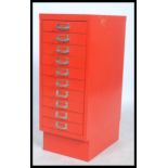 A 20th century Industrial Bisley ten drawers small filing cabinet on a plinth base in red having