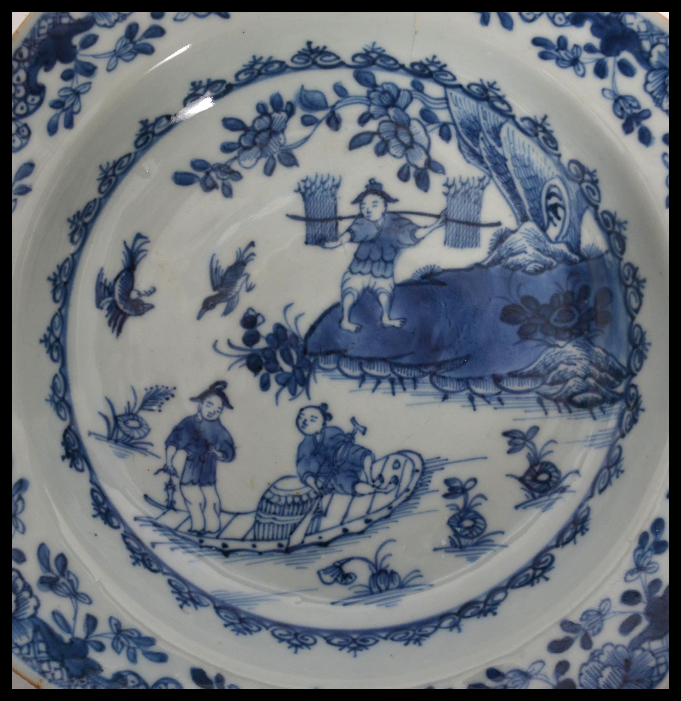 An 18th century Chinese porcelain blue and white plate, the plate decorated with domestic and - Image 3 of 4