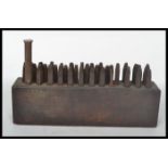 A collection of vintage industrial  20th century letter and number punches all stored within