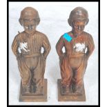 A pair of large cast metal fireside companions / door stops in the form of Dutch Boys