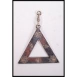 An unusual silver hallmarked Masonic triangular pendant by L SImpson & Co London. London hallmarks