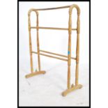 An early 20th century Beech wood towel rail raised on turned supports and rails. Measures: 82cm high
