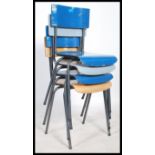A set of four retro style stacking dining chairs, raised on chrome frames with each seat pad