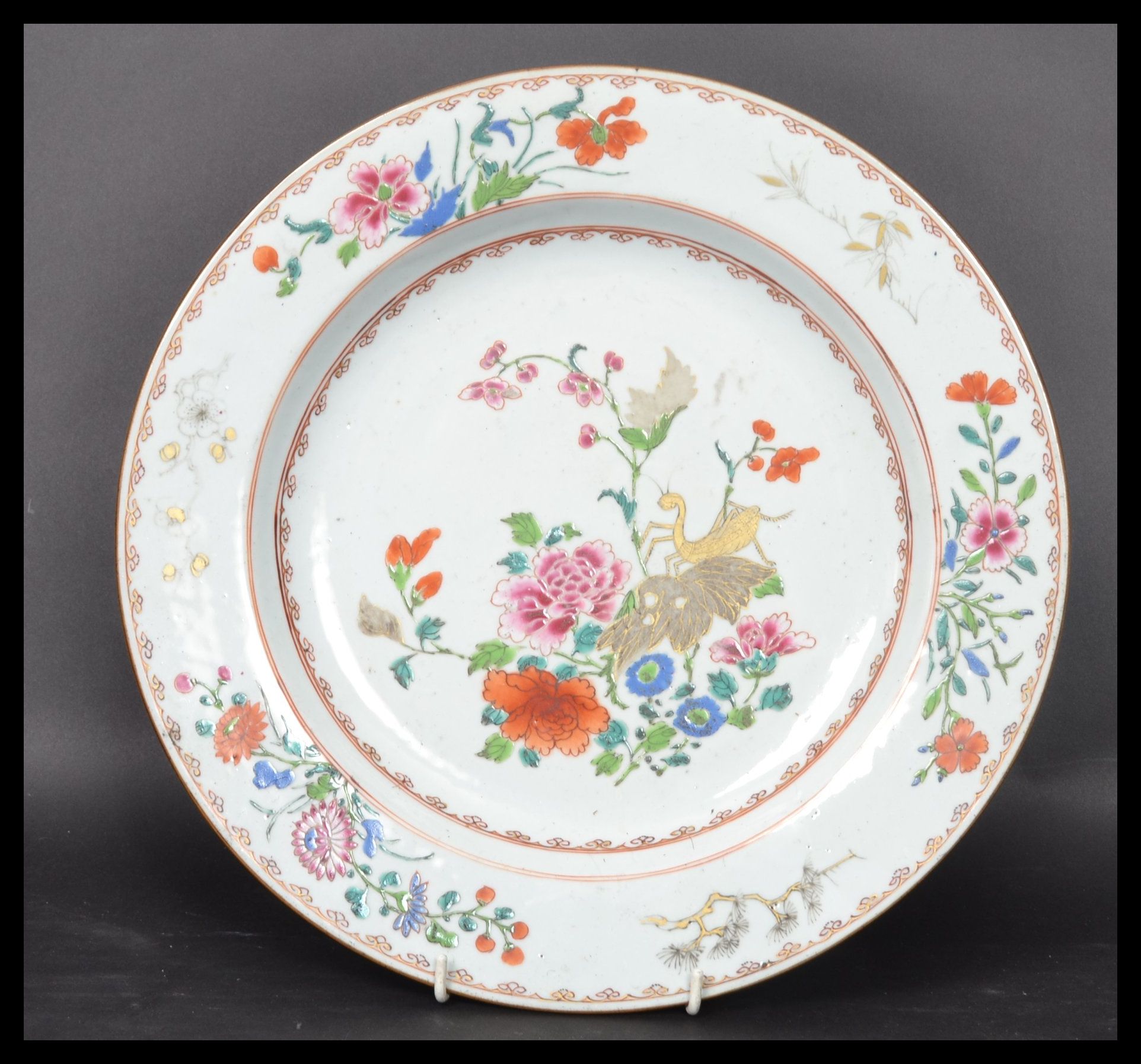 An 18th century Chinese Qing Long Famille Rose plate hand painted with enamels depicting floral