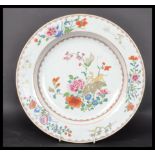 An 18th century Chinese Qing Long Famille Rose plate hand painted with enamels depicting floral