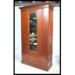 An Edwardian mahogany inlaid single wardrobe being raised on a plinth  base with a short drawer