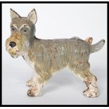 A vintage 20th century painted cast iron novelty doorstop figurine in the form of a urinating