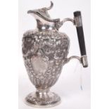 A stunning 19th century silver plated Claret Jug of urn form raised on a pedestal foot, heavily