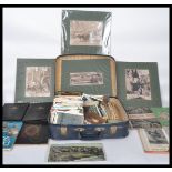 Suitcase with miscellany of unsorted postcards, stamps, ephemera, photos.