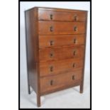 A 1930's Art Deco oak chest of drawers having, six graduating drawers fitted with drop handles and