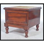 A Victorian mahogany step commode being raised on turned legs with pull out step, hinged carpet