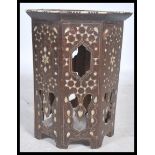 An Eastern 19th century octagonal Benares table profusely inlaid with silver, mother of pearl and