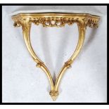 A vintage 20th century small marble topped gilt scroll work wall mounted console table. Measures: