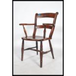 A 19th century Victorian beech and elm Oxford bar back Windsor carver chair raised on turned legs
