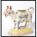 A 19th century Victorian Staffordshire pottery milk creamer jug in the form of a cow with painted
