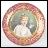 A 19th century hand painted cabinet plate having a red border with gilt decoration. The plate