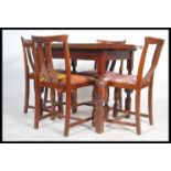 A 1930's Art Deco oak draw leaf refectory dining table and 4 chairs. The table with block and turned