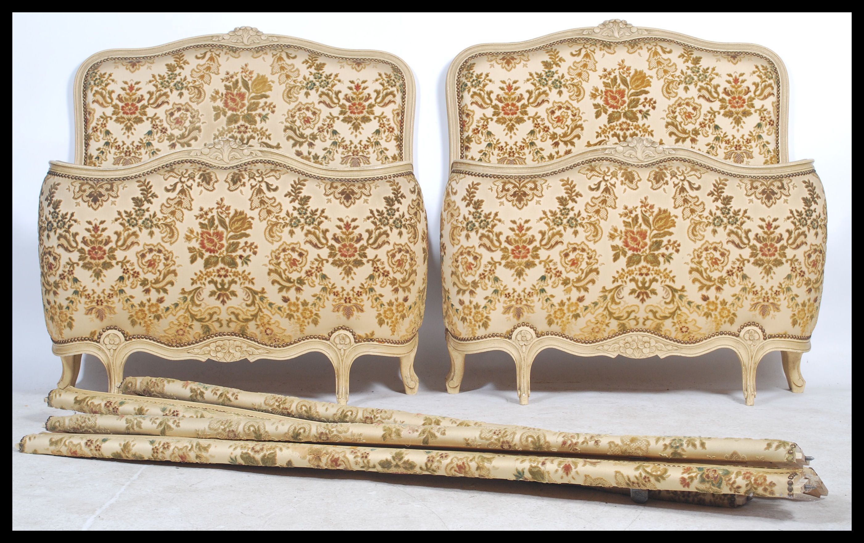 A pair of vintage 20th century French Single Corbeille beds having shabby chic painted head and