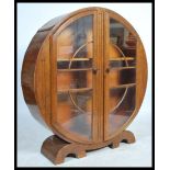 A 1930's Art Deco oak china roundel display cabinet. The round circular cabinet with twin doors