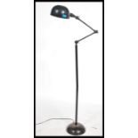 A retro mid century Industrial factory standard lamp raised on terraced base having tall