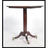 A 19th century mahogany side table being raised on shaped and reeded legs with brass cap castors