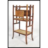 A 19th century Victorian aesthetic movement bamboo Canterbury magazine stand having a wicker panel