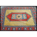 A large 20th century Persian woollen rug having a central medallion with beige ground having
