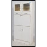 A retro 1950's painted wooden kitchen dresser cabinet comprising a series of cupboards and drawers
