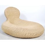 A contemporary whicker oversized chaise longue day bed of pebble form with shaped back rest.