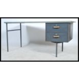 A retro mid 20th century military / industrial single pedestal desk, raised on metal tubular legs